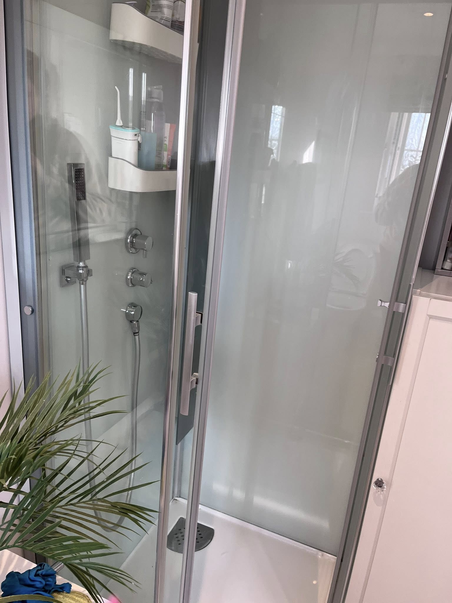 A very clean shower with reflections visible in the glass